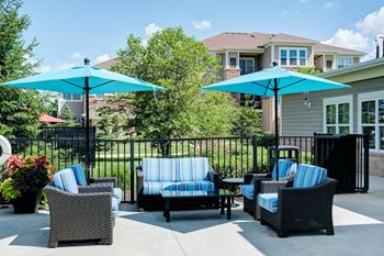Shaded poolside lounge area with plush seating